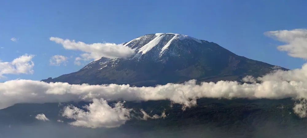 Kilimanjaro's snow cap above its collar of cloud, seen from the south